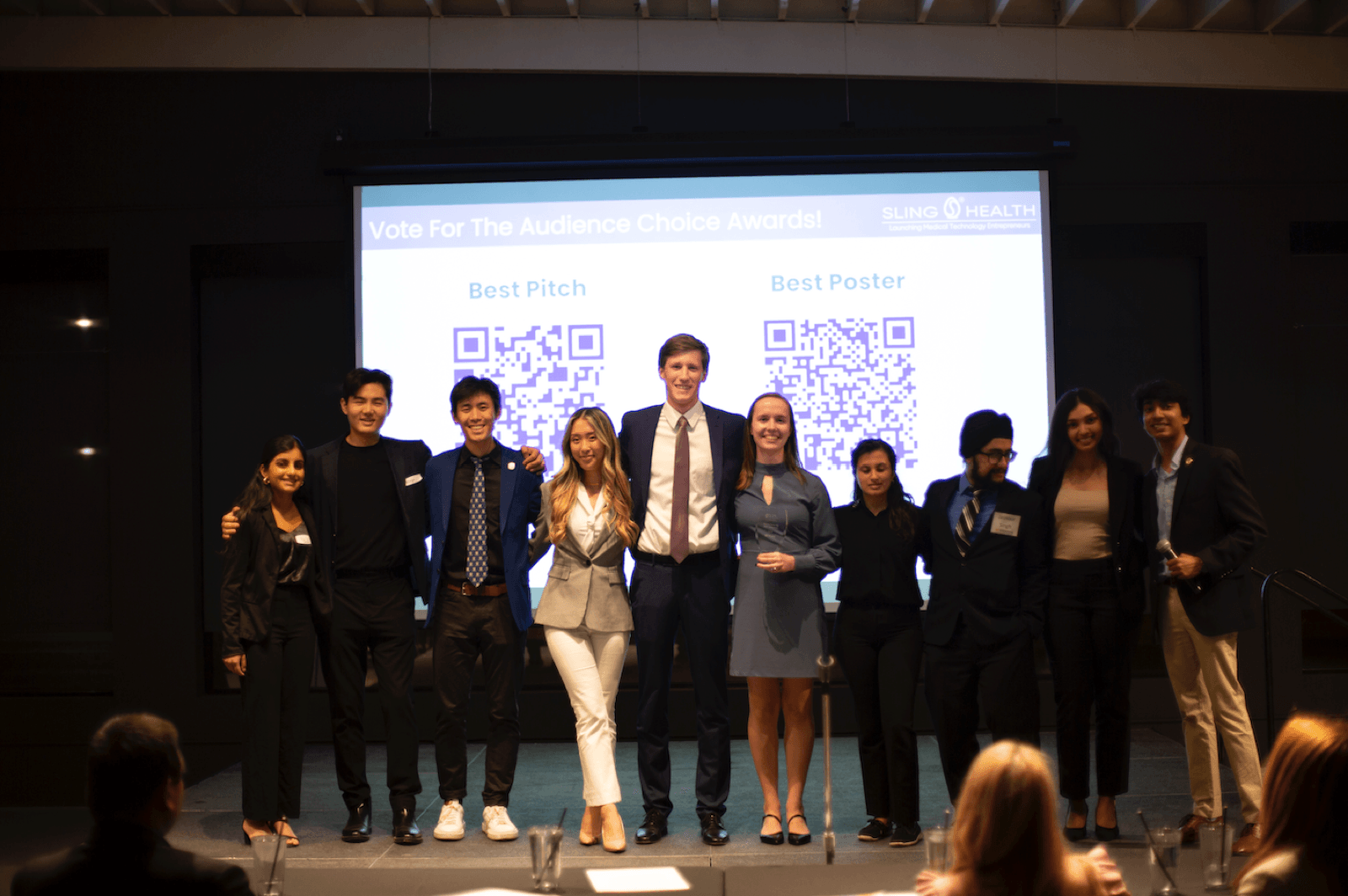 A Sling Health team on stage at Demo Day during the Audience Choice awards.